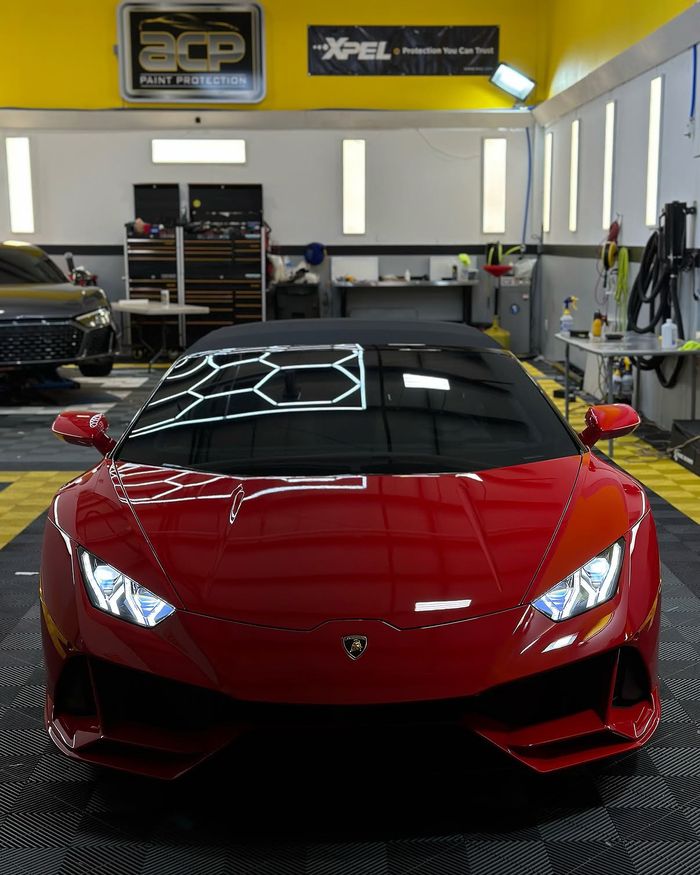 A red Lamborghini Huracán nose-on in the ACP bay