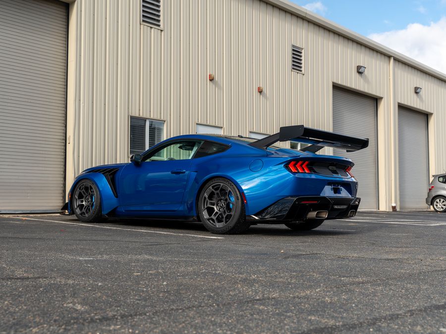 A finished blue Ford Mustang GTD, parked outside